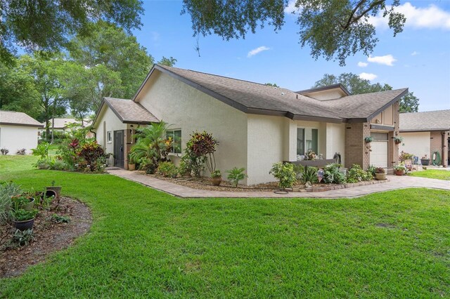 view of front of home with a garage and a front yard