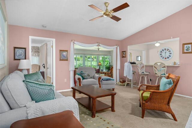 carpeted living room featuring vaulted ceiling and ceiling fan