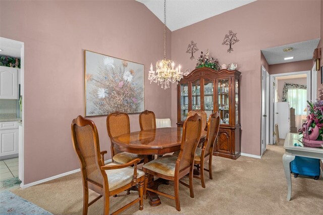 carpeted dining room featuring an inviting chandelier and vaulted ceiling