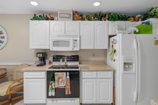 kitchen featuring tasteful backsplash, a textured ceiling, white cabinets, and white appliances