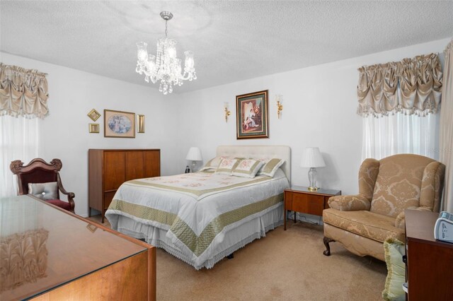 bedroom with light colored carpet, a textured ceiling, and a chandelier