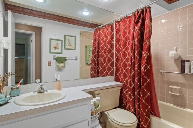 full bathroom with vanity, toilet, and shower / tub combo with curtain