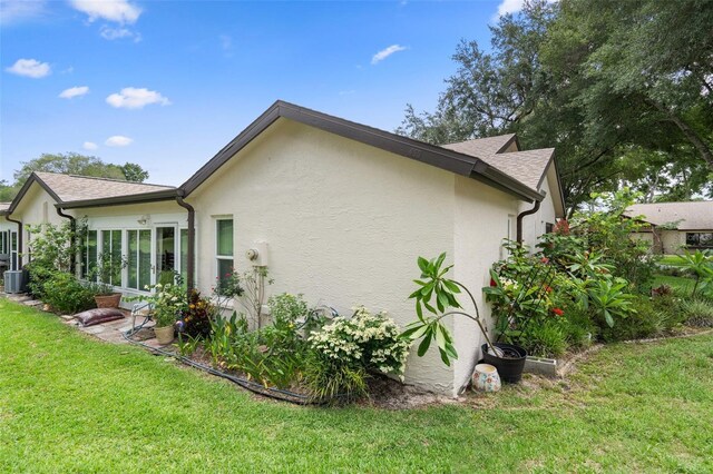 view of home's exterior with a yard