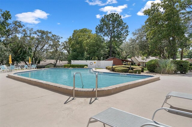 view of swimming pool with a patio area