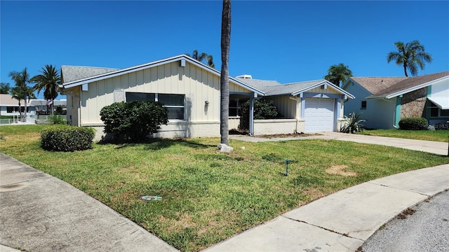 view of front of home with a front lawn and a garage