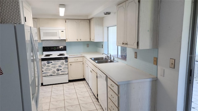 kitchen with light tile patterned floors, decorative backsplash, sink, and white appliances