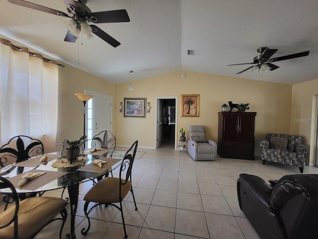 tiled dining space featuring vaulted ceiling and ceiling fan