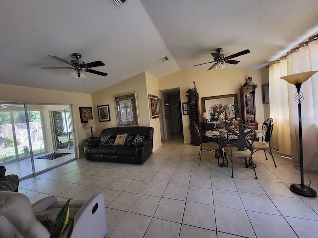 tiled living room with a textured ceiling, lofted ceiling, and ceiling fan