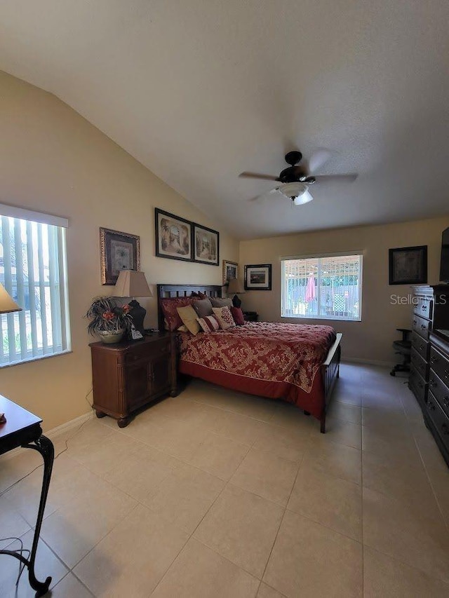 tiled bedroom with ceiling fan and vaulted ceiling