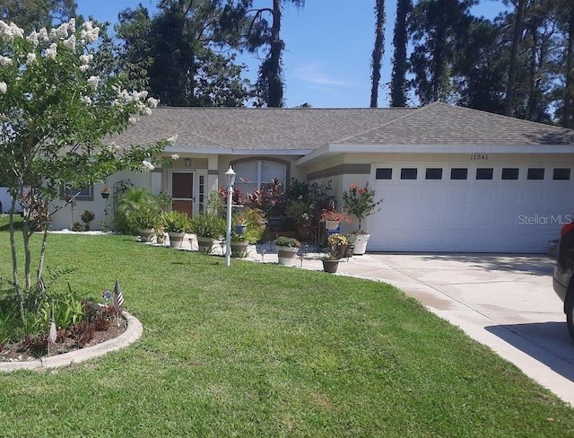 ranch-style home featuring a front lawn and a garage