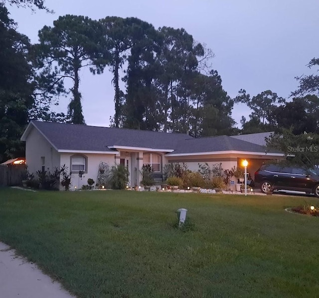 ranch-style house featuring a lawn