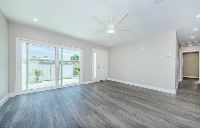 unfurnished room featuring dark hardwood / wood-style flooring, a textured ceiling, and ceiling fan