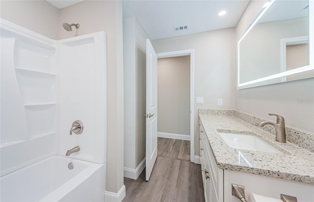 bathroom with shower / bath combination, vanity, and hardwood / wood-style flooring