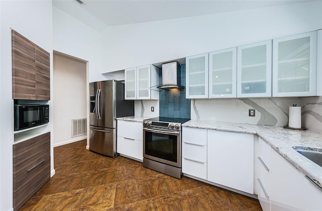 kitchen with white cabinetry, wall chimney exhaust hood, stainless steel appliances, and light stone counters