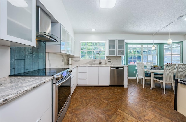 kitchen with sink, hanging light fixtures, a textured ceiling, white cabinets, and appliances with stainless steel finishes