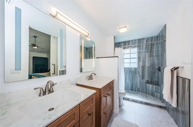 bathroom featuring a shower with shower curtain, vanity, toilet, and ceiling fan