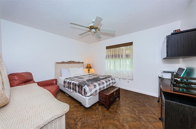 bedroom featuring a textured ceiling and ceiling fan