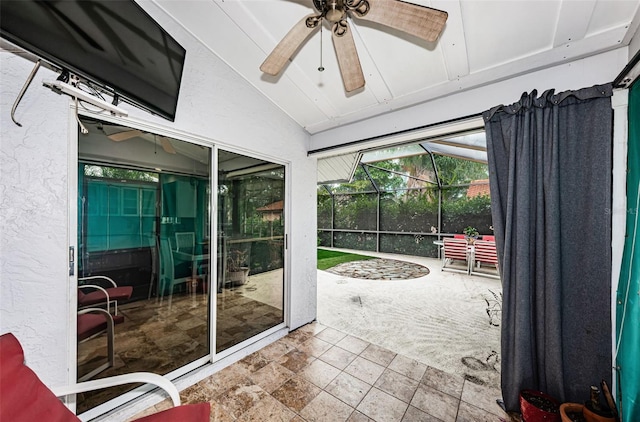 sunroom / solarium featuring ceiling fan and vaulted ceiling