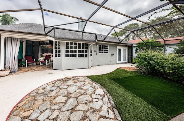 back of property featuring french doors, a lanai, and a patio area