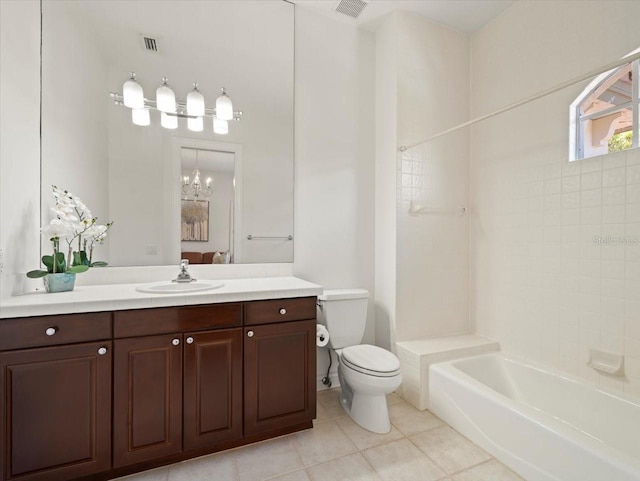 full bathroom featuring tile patterned floors, tiled shower / bath combo, vanity, a notable chandelier, and toilet