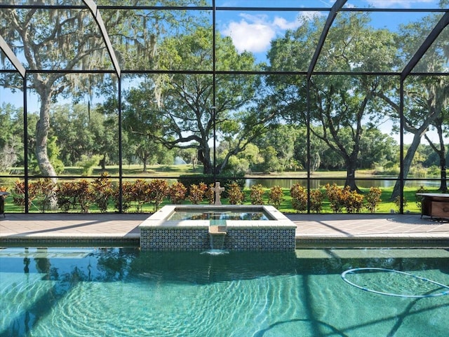 view of pool with a lanai, an in ground hot tub, and a patio