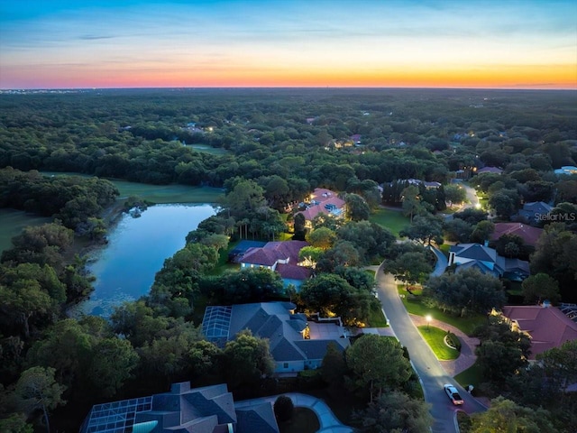 aerial view at dusk with a water view