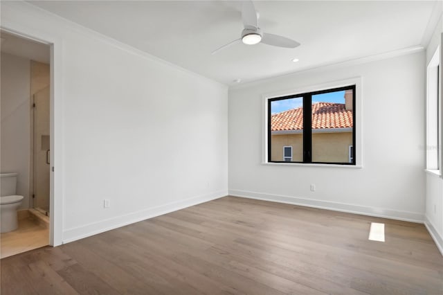 unfurnished room featuring recessed lighting, ornamental molding, a ceiling fan, wood finished floors, and baseboards