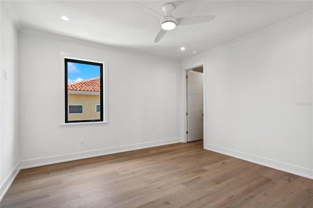 empty room with baseboards, a ceiling fan, wood finished floors, crown molding, and recessed lighting