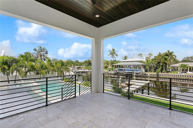 view of patio / terrace with a water view and a balcony