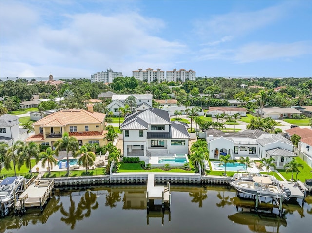 drone / aerial view with a water view and a residential view