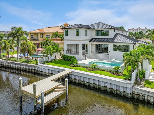 dock area with a patio area and a water view