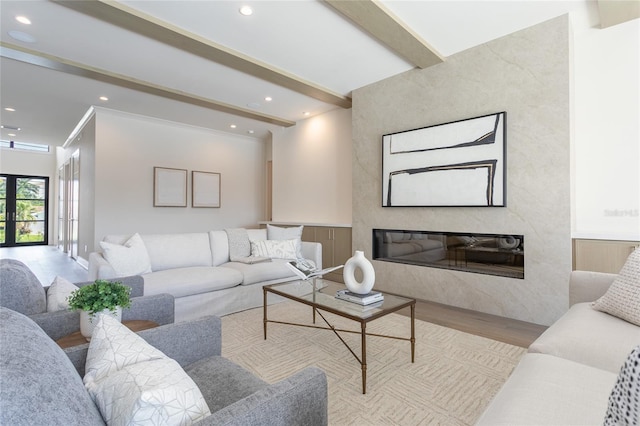 living area with a premium fireplace, beamed ceiling, recessed lighting, and wood finished floors
