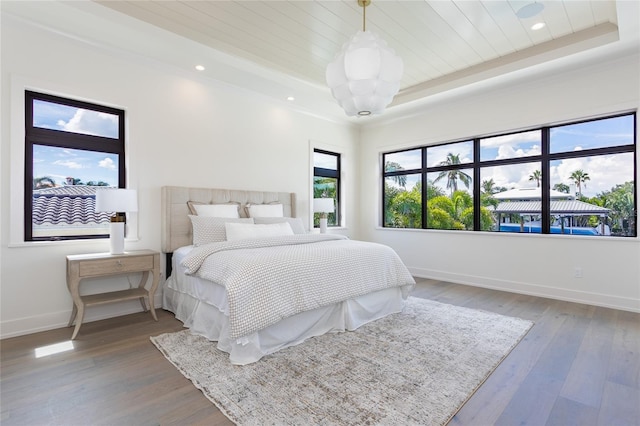 bedroom with wood ceiling, baseboards, and wood finished floors