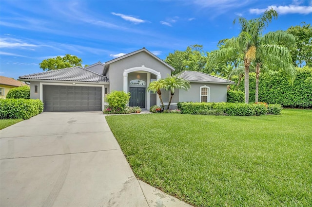 view of front of house with a garage and a front yard