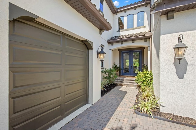 doorway to property with french doors and a garage