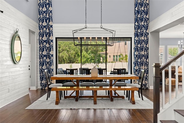 dining room featuring dark wood-type flooring and an inviting chandelier