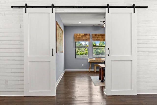 interior space with dark hardwood / wood-style floors and a barn door