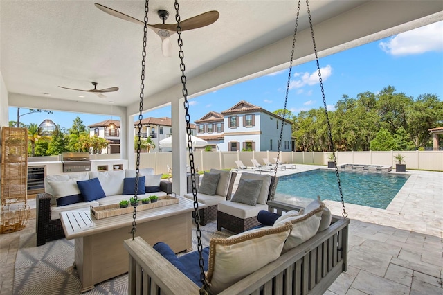 view of patio / terrace with outdoor lounge area, ceiling fan, a grill, pool water feature, and a fenced in pool