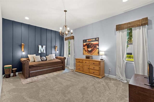 bedroom featuring light carpet and a notable chandelier