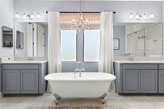 bathroom featuring vanity, shower with separate bathtub, and an inviting chandelier