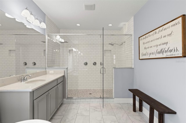 bathroom with vanity and a shower with shower door