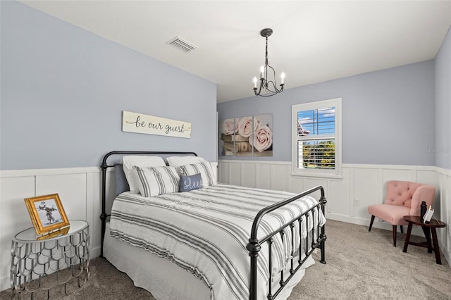 carpeted bedroom featuring a notable chandelier