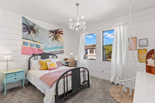 bedroom featuring wooden walls, carpet floors, and a notable chandelier