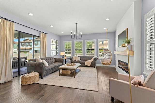 living room with wood-type flooring and a notable chandelier