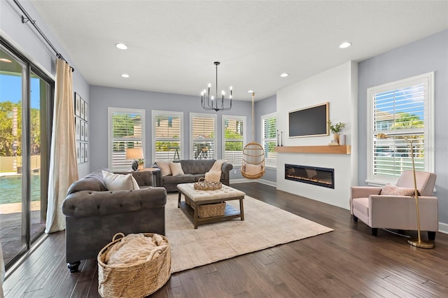 living room featuring dark hardwood / wood-style flooring and a chandelier