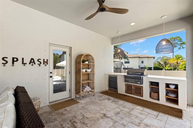 view of patio / terrace with area for grilling, a grill, ceiling fan, and beverage cooler