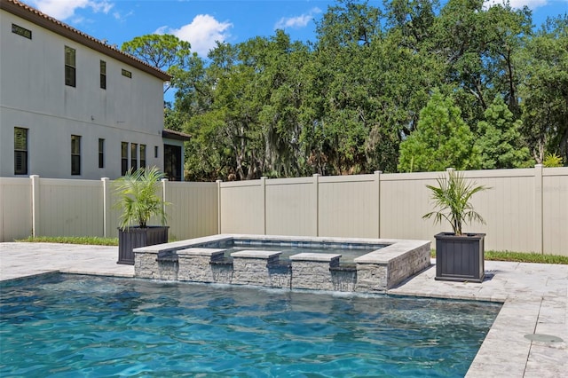 view of swimming pool featuring an in ground hot tub, pool water feature, and a patio area