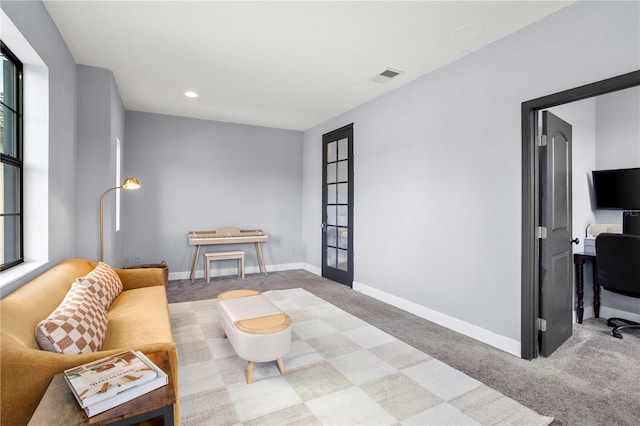 living room featuring carpet flooring and french doors