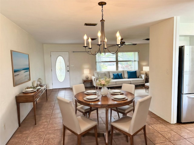 dining space featuring tile patterned floors and a notable chandelier