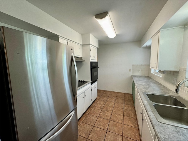 kitchen featuring white cabinetry, sink, backsplash, light tile patterned flooring, and black appliances